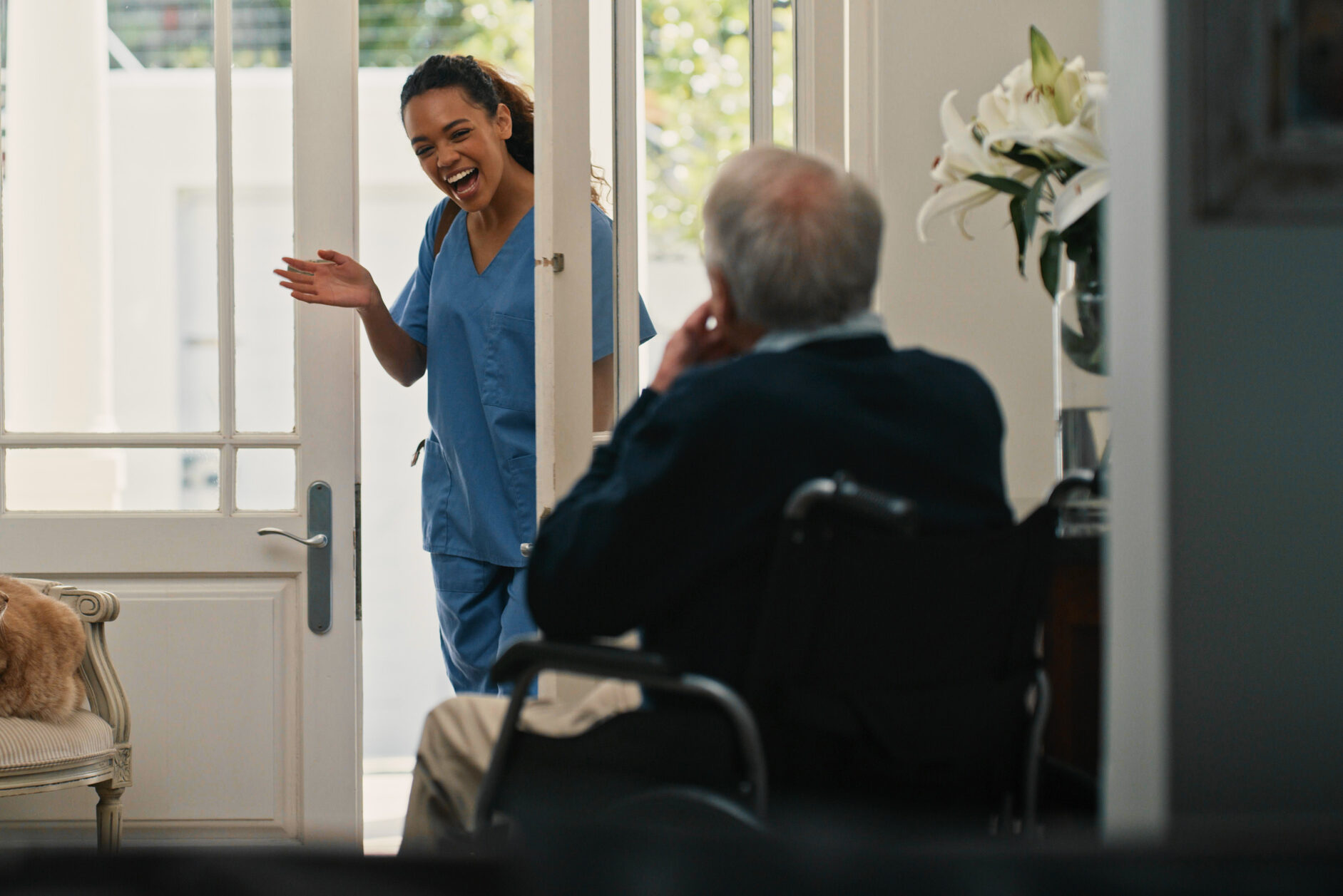 Home health care franchise - Shot of an attractive young nurse waving goodbye to her senior patient after completing her shift