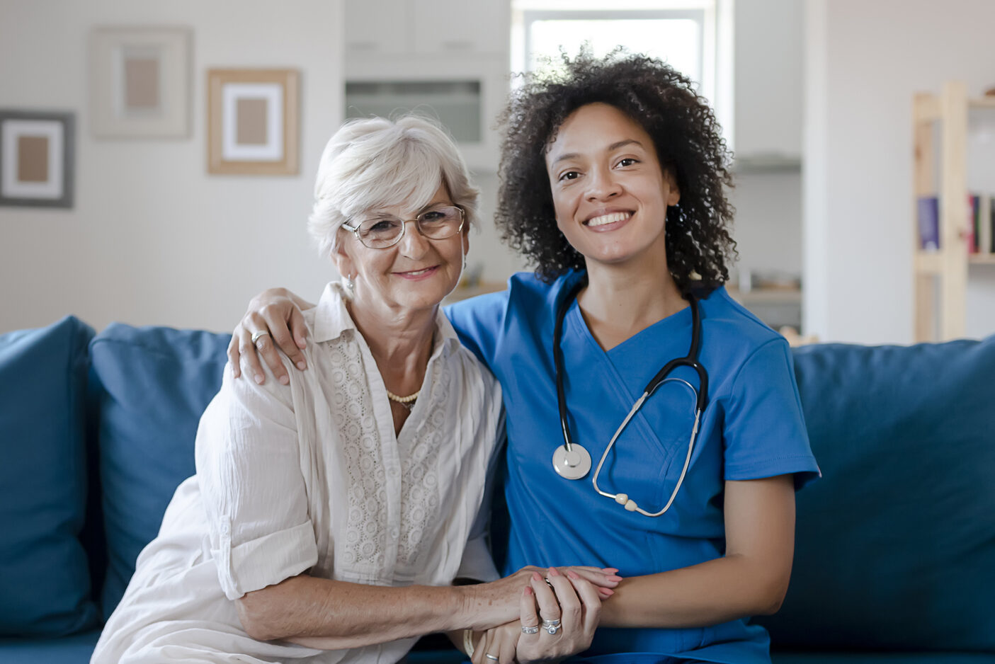 What to Ask a Franchisor About a Home Care Franchise Opportunity - Portrait of Smiling Senior Woman and Her Mixed Race Female Caregiver Together at Nursing Home. Caring Female Doctor Taking Care of a Happy, Elderly Woman